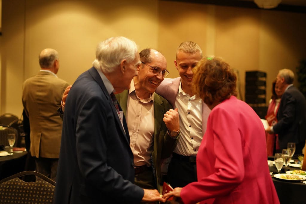 Guests sharing a laugh at the banquet